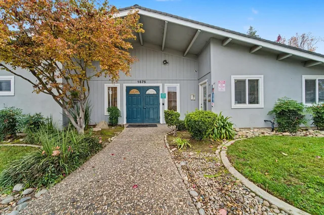 a bathroom with a granite countertop toilet sink and mirror