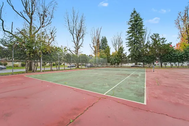 a bathroom with a granite countertop sink a toilet and a mirror