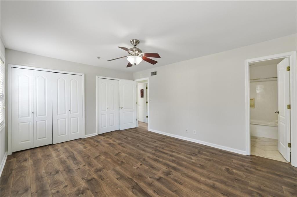 2825 Northeast Expressway, Unit F3 Atlanta, GA 30345 - Photo 28 of 45 a view of a room with a big room with wooden floor and a ceiling fan