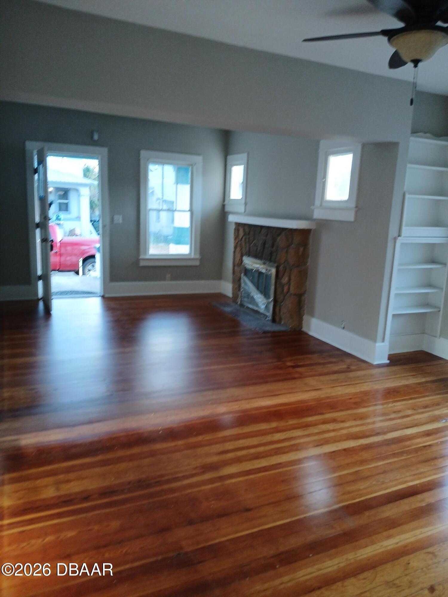 316 Michigan Avenue Daytona Beach, FL 32114 - Photo 4 of 9 a view of an empty room with wooden floor and a window