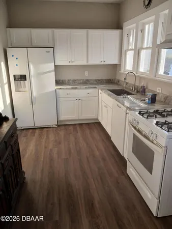 a kitchen with a stove a sink and a microwave