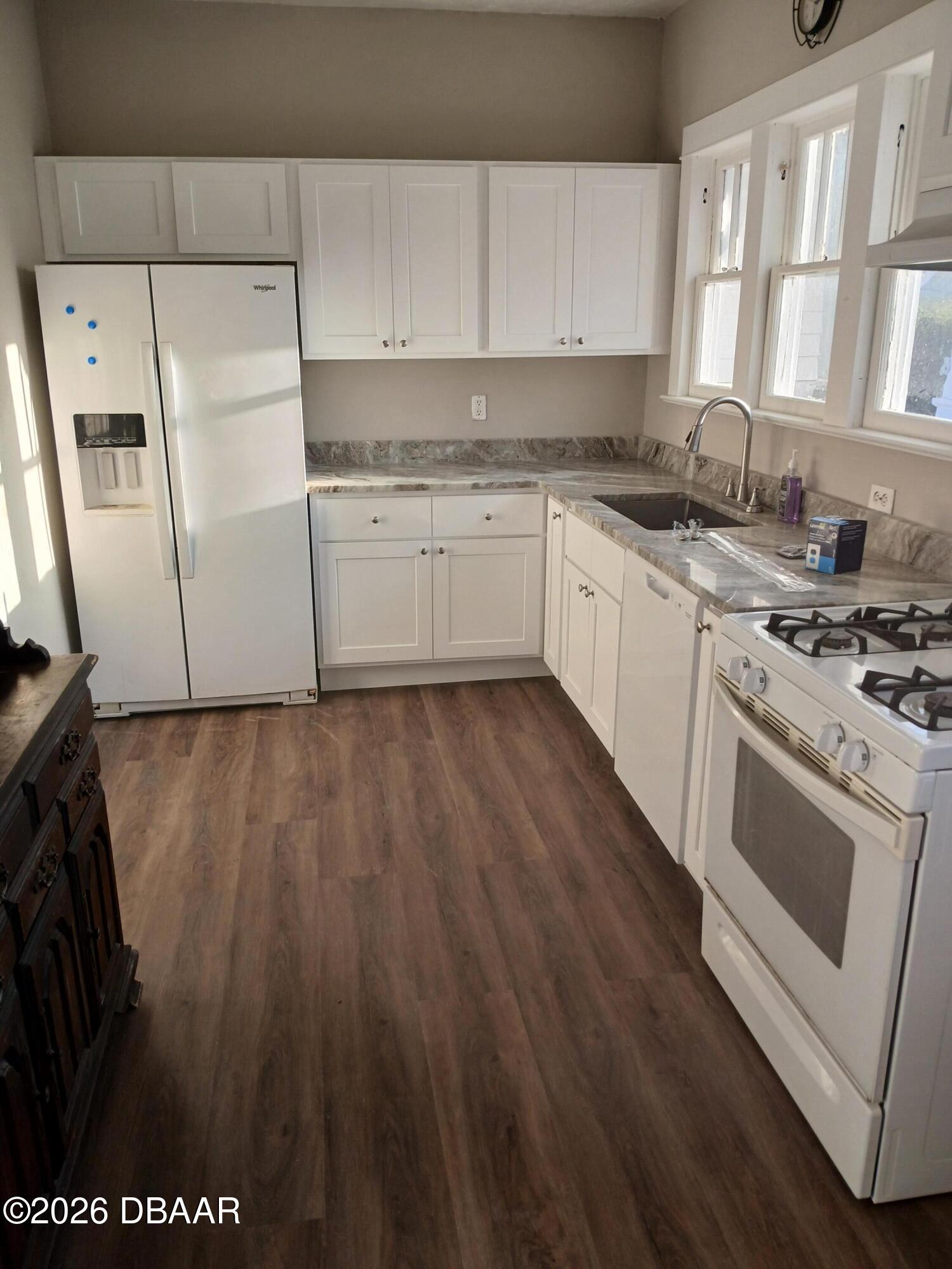 316 Michigan Avenue Daytona Beach, FL 32114 - Photo 5 of 9 a kitchen with a stove a sink and a microwave