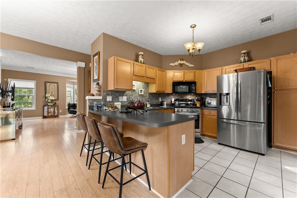 1628 Indian Way Cumming, GA 30040 - Photo 11 of 39 a kitchen with refrigerator and cabinets
