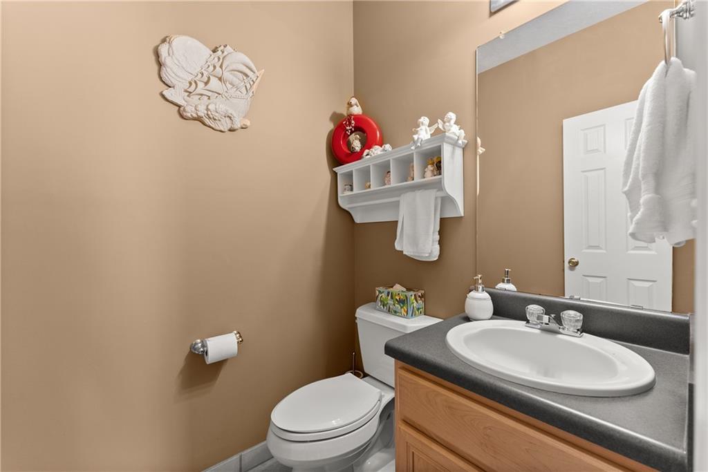 1628 Indian Way Cumming, GA 30040 - Photo 15 of 39 a bathroom with a sink vanity mirror and toilet