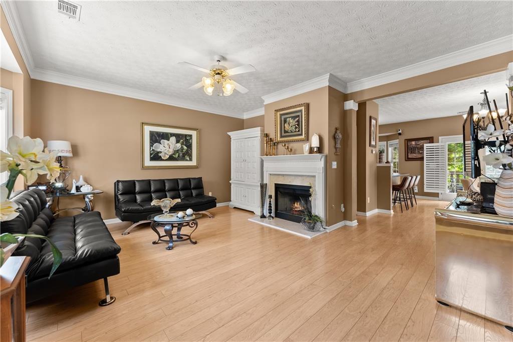 1628 Indian Way Cumming, GA 30040 - Photo 16 of 39 a living room with furniture and a fireplace