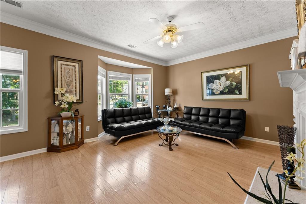 1628 Indian Way Cumming, GA 30040 - Photo 17 of 39 a living room with furniture and wooden floor