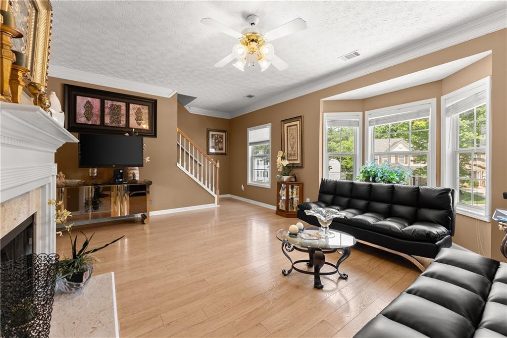 1628 Indian Way Cumming, GA 30040 - Photo 18 of 39 a living room with furniture and a large window
