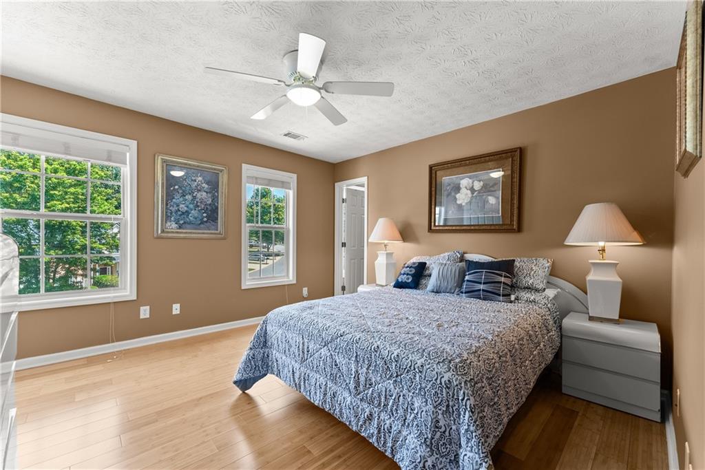 1628 Indian Way Cumming, GA 30040 - Photo 20 of 39 a bedroom with a large bed and a window