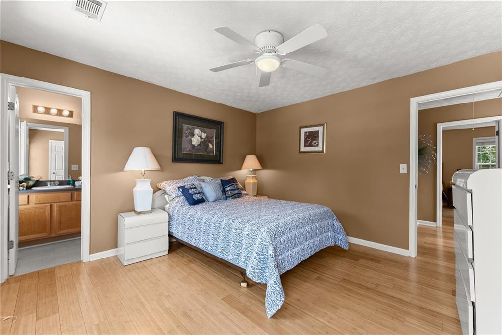 1628 Indian Way Cumming, GA 30040 - Photo 21 of 39 a bedroom with a bed and a chandelier