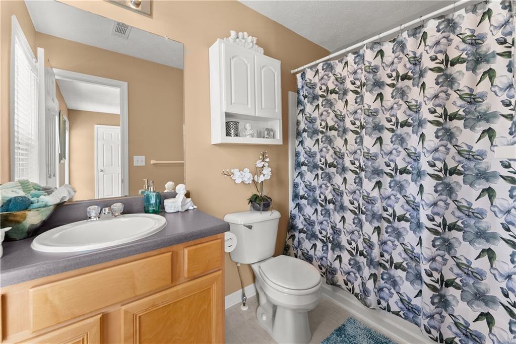 1628 Indian Way Cumming, GA 30040 - Photo 22 of 39 a bathroom with a sink toilet and shower