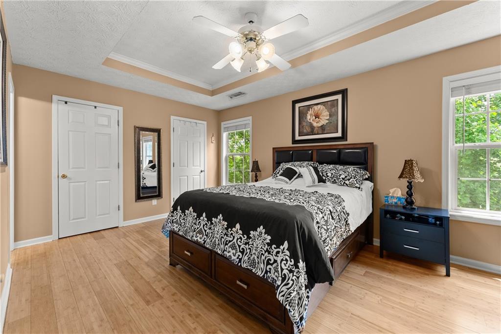 1628 Indian Way Cumming, GA 30040 - Photo 25 of 39 a bedroom with a bed and a ceiling fan