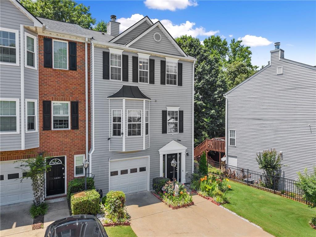1628 Indian Way Cumming, GA 30040 - Photo 3 of 39 a front view of a house with garden