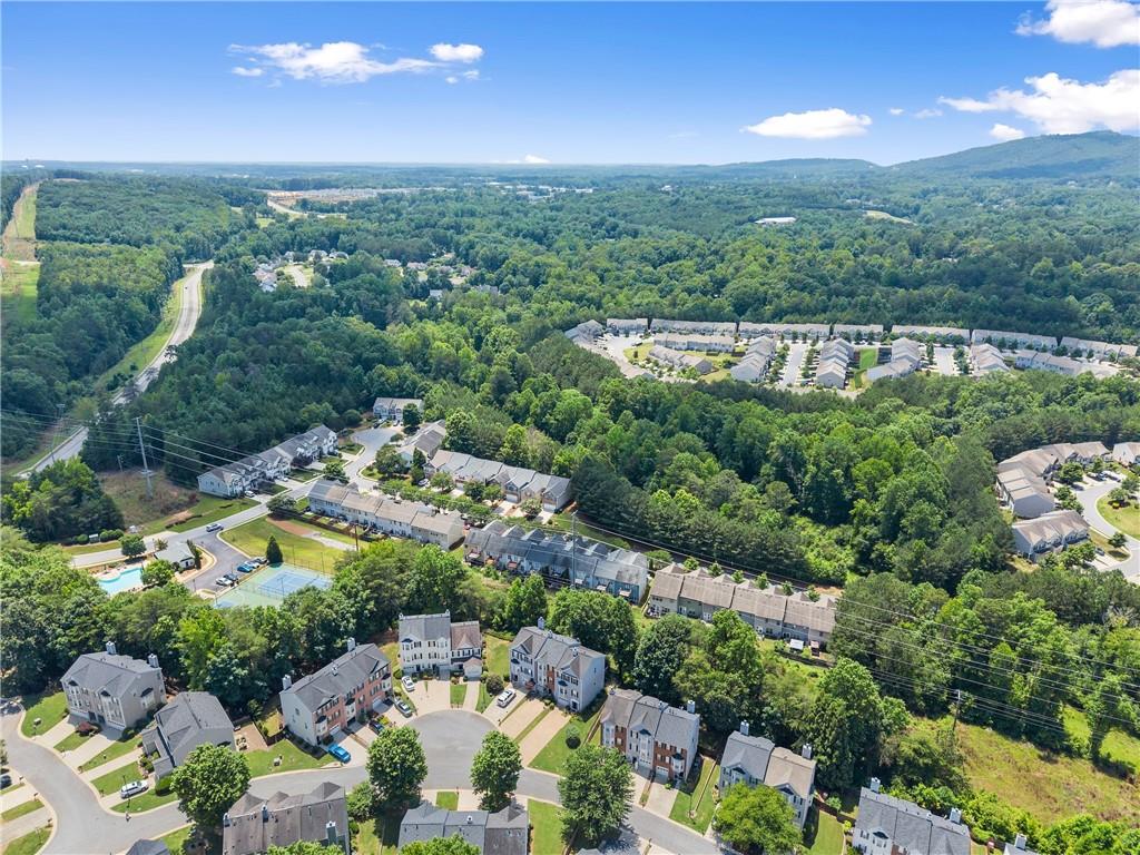 1628 Indian Way Cumming, GA 30040 - Photo 35 of 39 an aerial view of a city with lots of residential buildings and mountain view in back