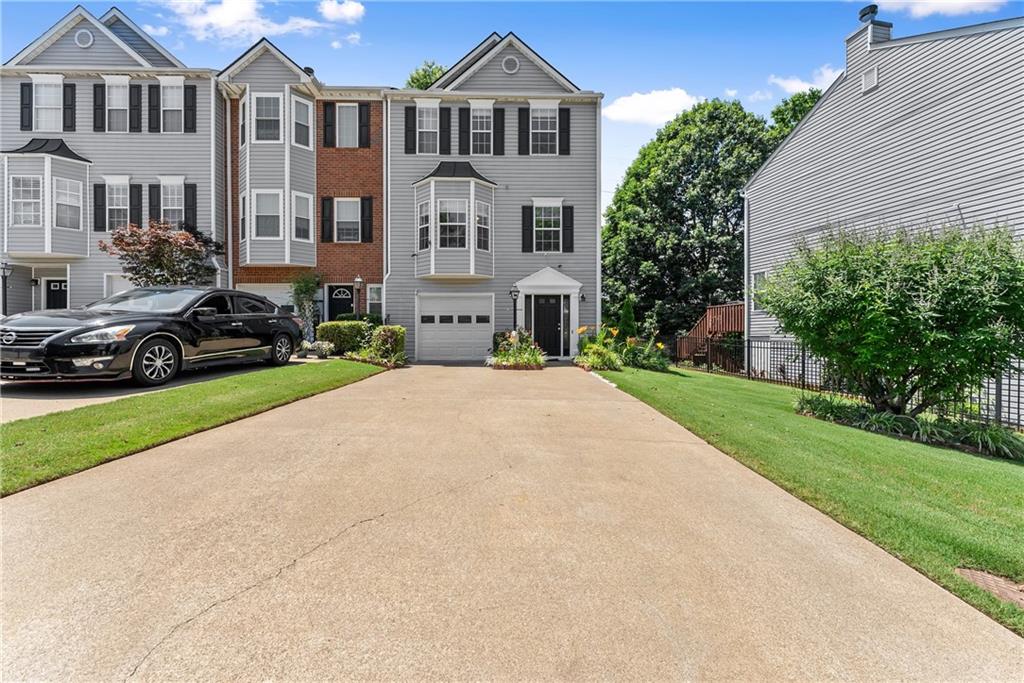 1628 Indian Way Cumming, GA 30040 - Photo 4 of 39 a front view of a house with a yard and garage