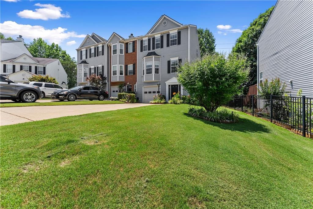 1628 Indian Way Cumming, GA 30040 - Photo 5 of 39 a view of multiple houses with yard and green space