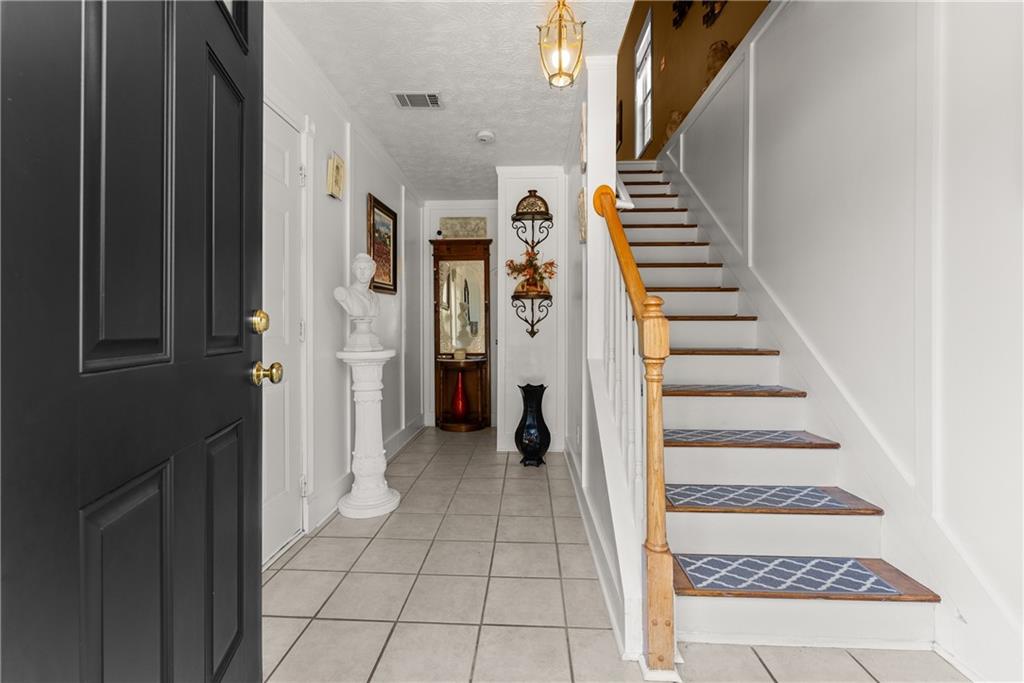 1628 Indian Way Cumming, GA 30040 - Photo 6 of 39 a view of a hallway with entryway and stairs