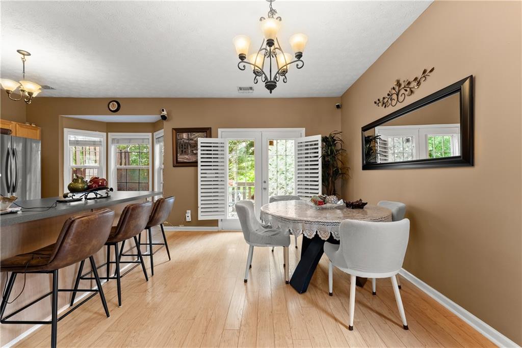 1628 Indian Way Cumming, GA 30040 - Photo 7 of 39 a view of a dining room with furniture window and wooden floor