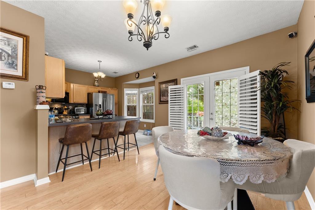 1628 Indian Way Cumming, GA 30040 - Photo 8 of 39 a dining room with furniture window and wooden floor