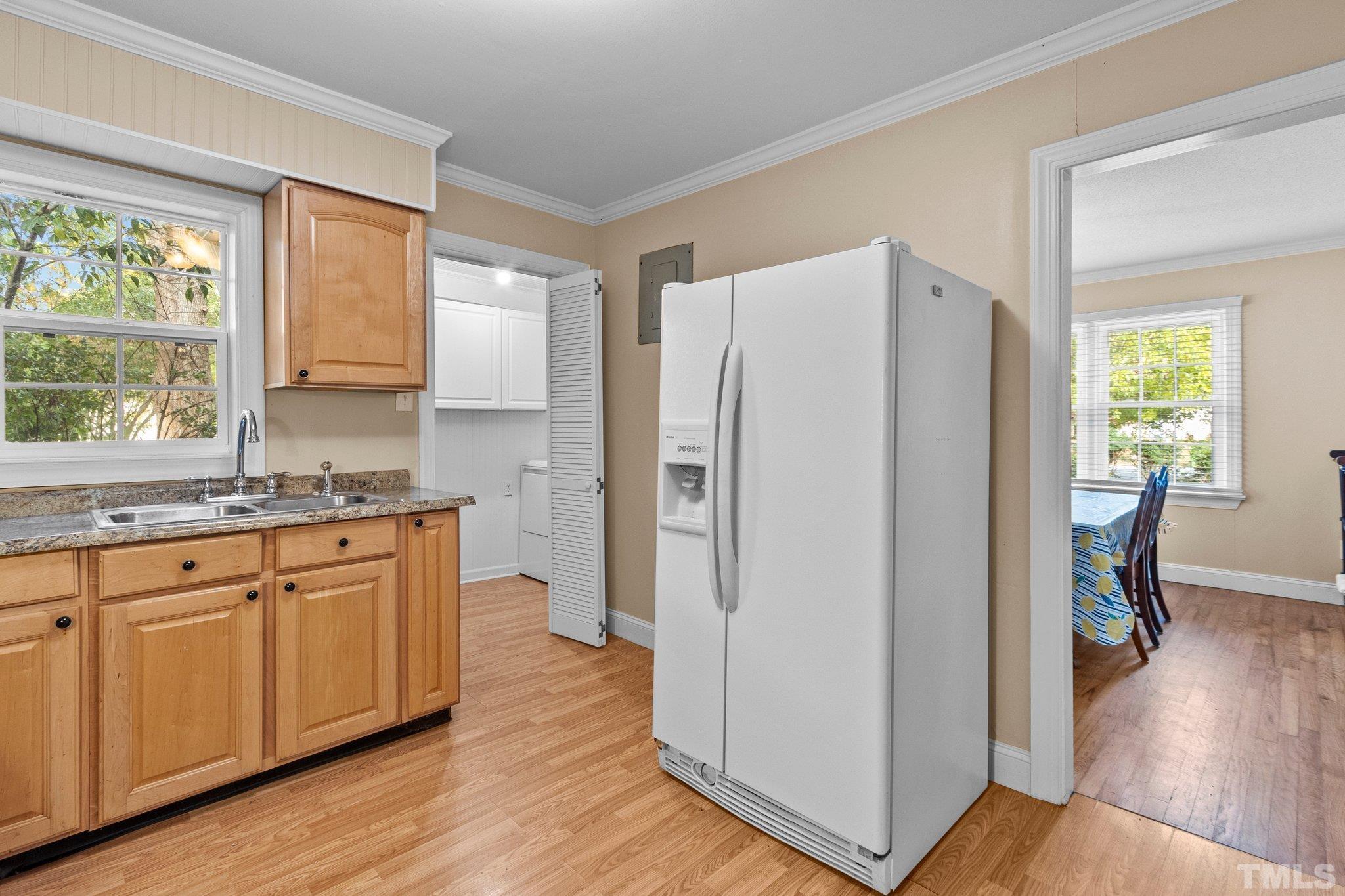 1713 Oberlin Road Raleigh, NC 27608 - Photo 11 of 34 a kitchen with stainless steel appliances a refrigerator a sink a stove a dining table and chairs