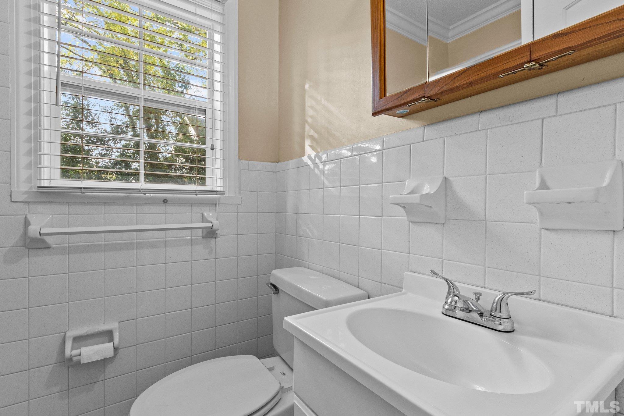 1713 Oberlin Road Raleigh, NC 27608 - Photo 18 of 34 a bathroom with a toilet sink and mirror