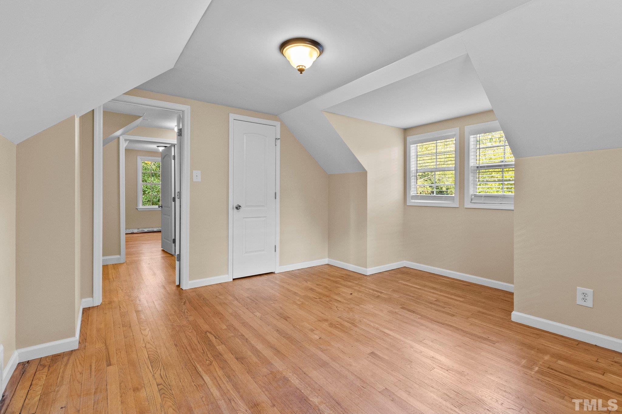 1713 Oberlin Road Raleigh, NC 27608 - Photo 22 of 34 an empty room with wooden floor and windows