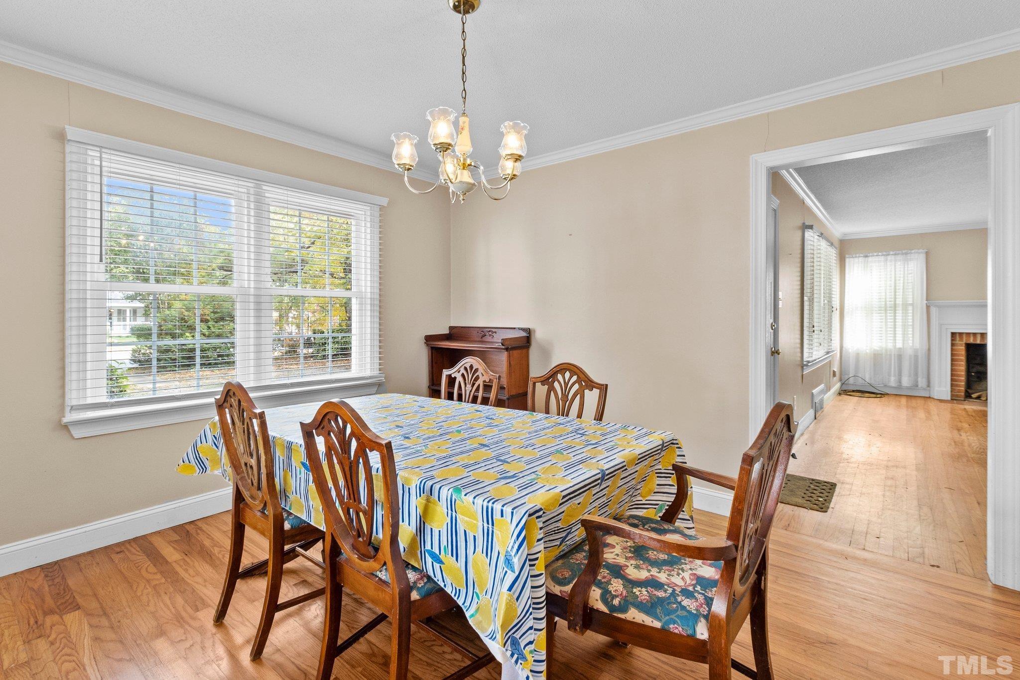 1713 Oberlin Road Raleigh, NC 27608 - Photo 7 of 34 a bedroom that has a bed and a chandelier