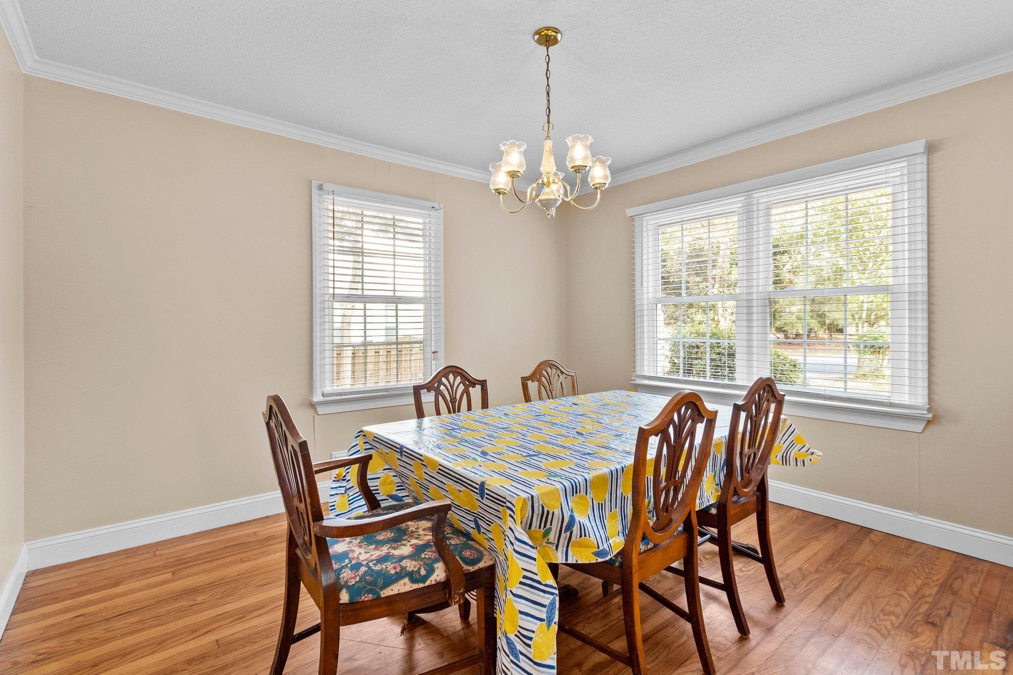 1713 Oberlin Road Raleigh, NC 27608 - Photo 8 of 34 a view of a dining room with furniture window and wooden floor