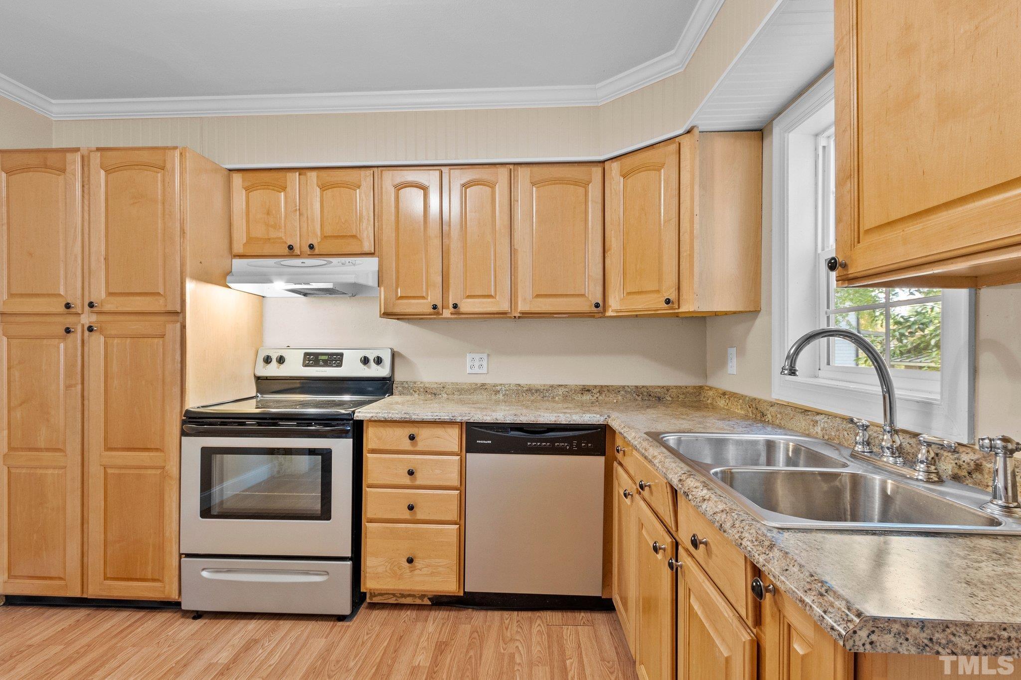 1713 Oberlin Road Raleigh, NC 27608 - Photo 10 of 34 a kitchen with a sink stove top oven and cabinets