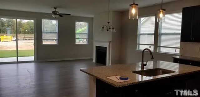 a kitchen with kitchen island a sink appliances and a large window