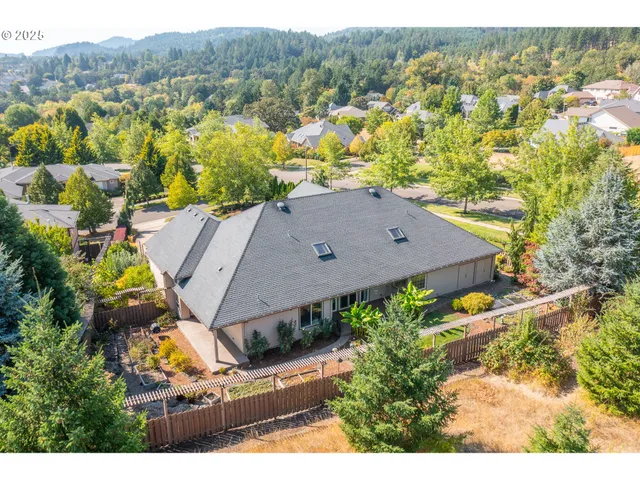 a front view of a house with a yard and potted plants