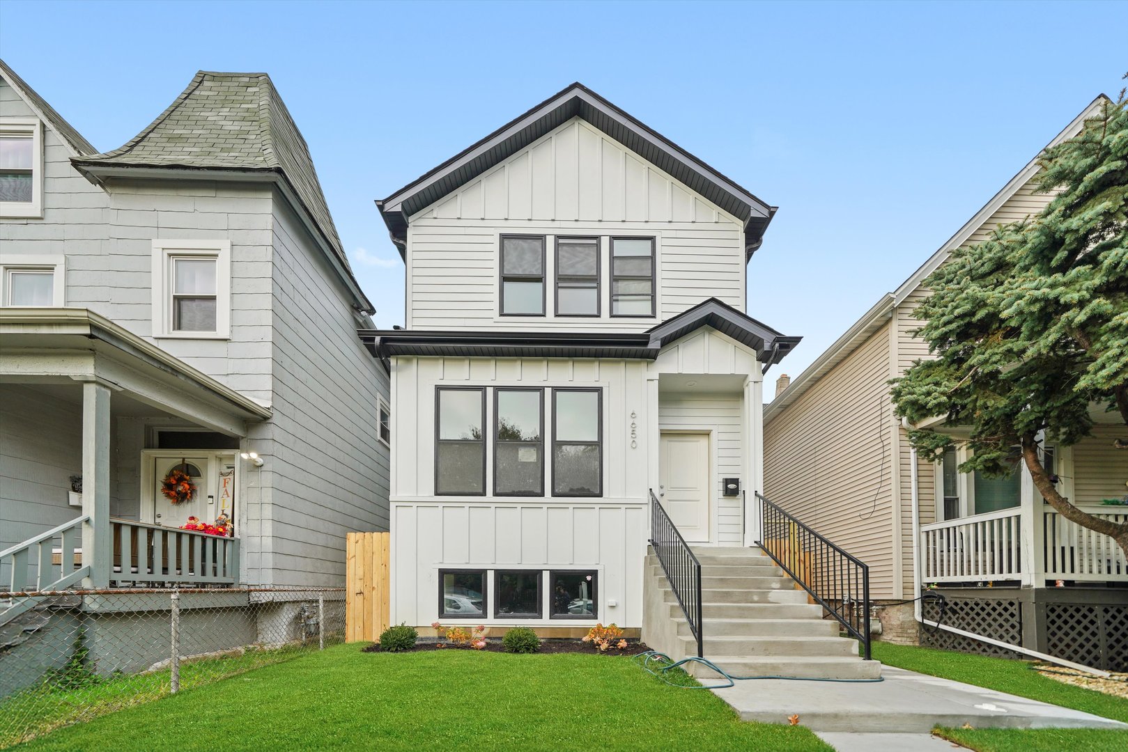 a view of house with yard and stairs