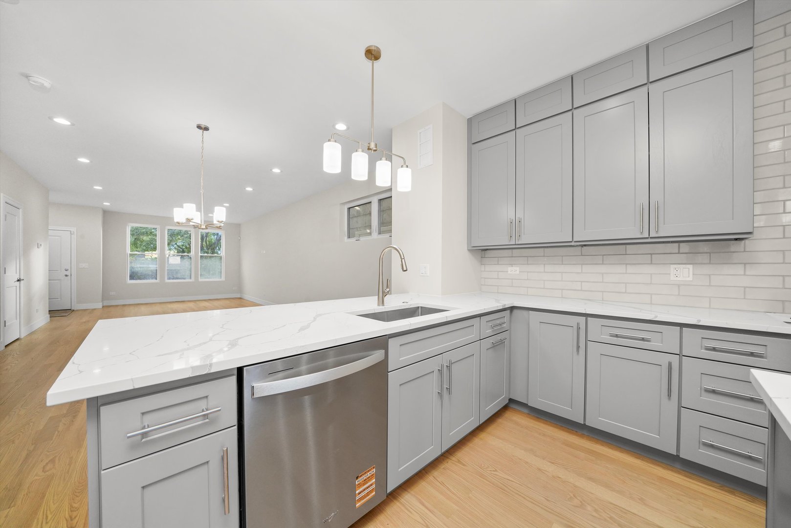 6650 South Wabash Avenue Chicago, IL 60637 - Photo 2 of 14 a kitchen with a sink dishwasher and white cabinets with wooden floor