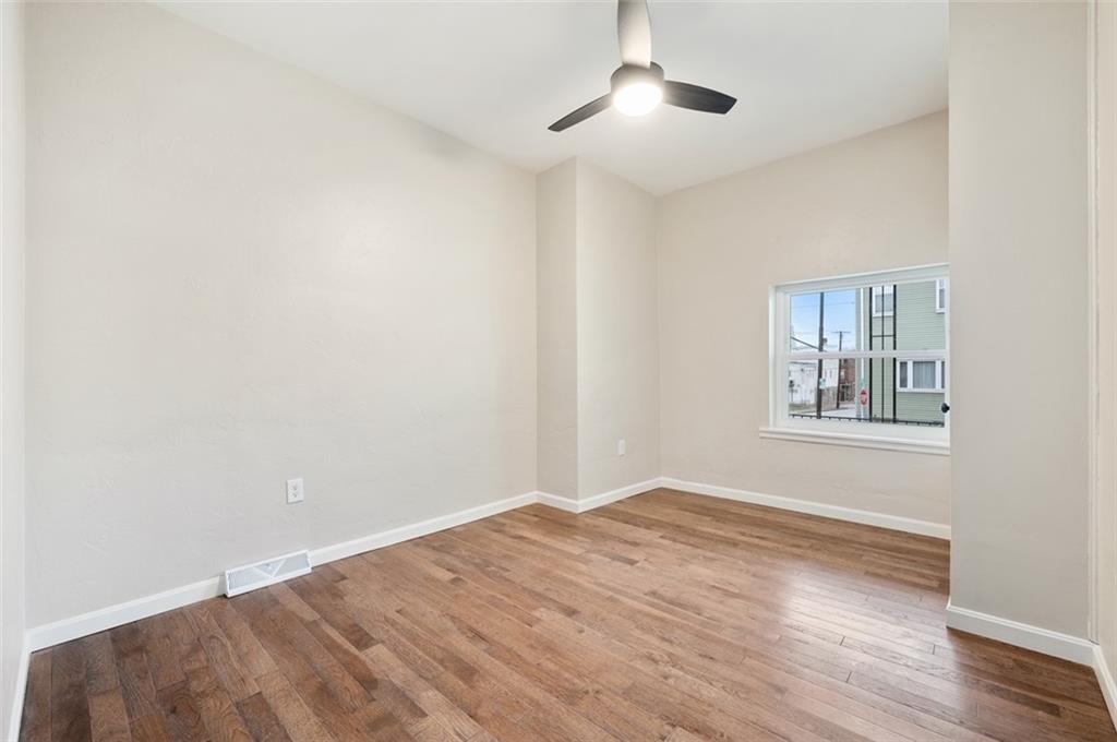 4827 Sciota Street Pittsburgh, PA 15224 - Photo 13 of 19 a view of an empty room with wooden floor and a window