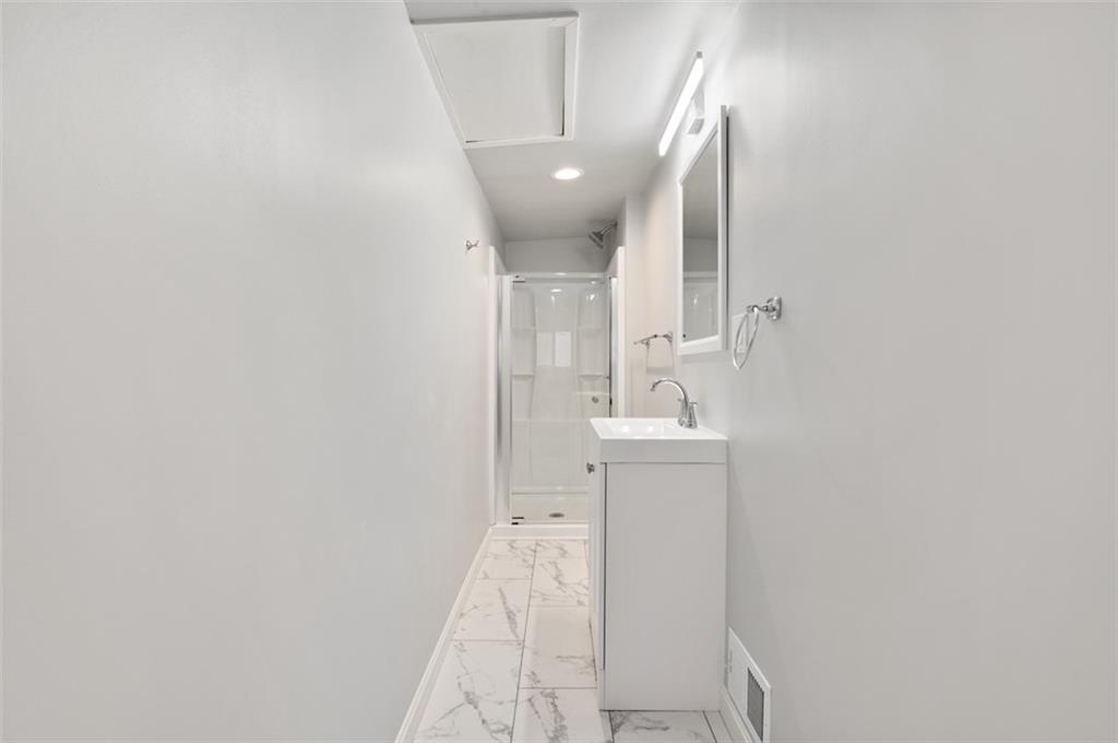 4827 Sciota Street Pittsburgh, PA 15224 - Photo 14 of 19 a bathroom with a sink and a mirror