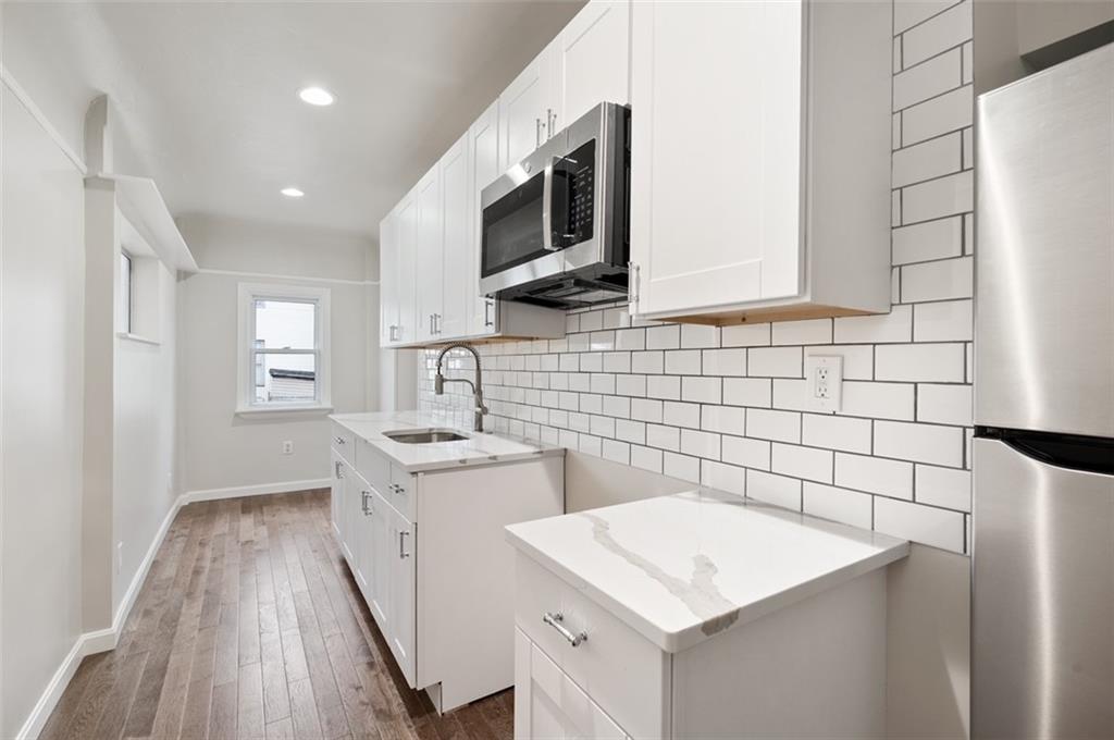 4827 Sciota Street Pittsburgh, PA 15224 - Photo 15 of 19 a kitchen with a sink stove and microwave