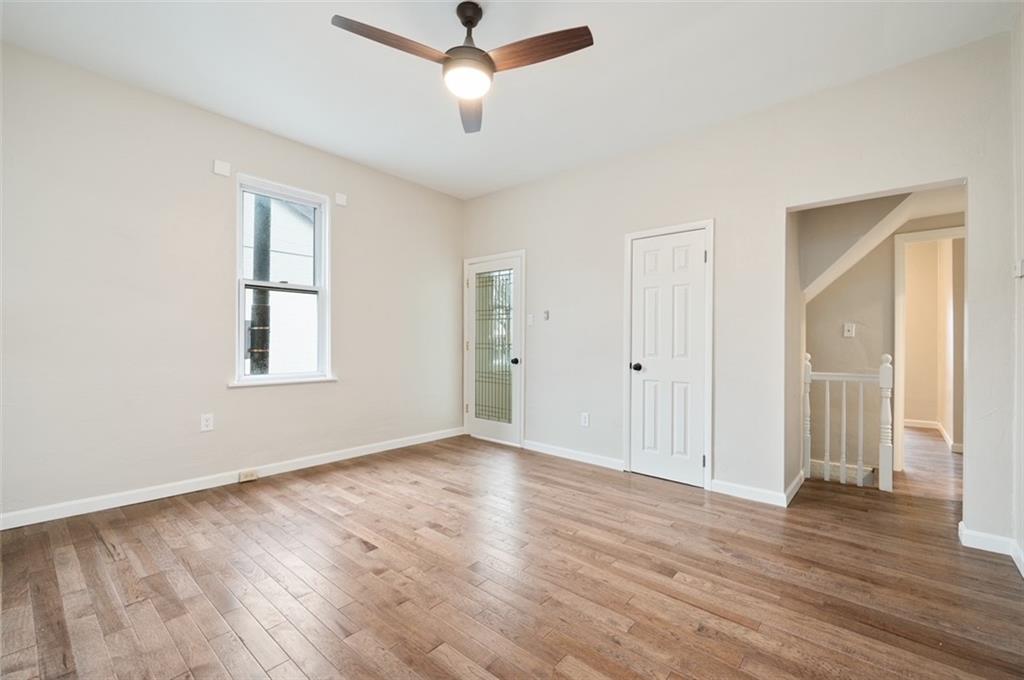 4827 Sciota Street Pittsburgh, PA 15224 - Photo 17 of 19 a view of an empty room with wooden floor and a window