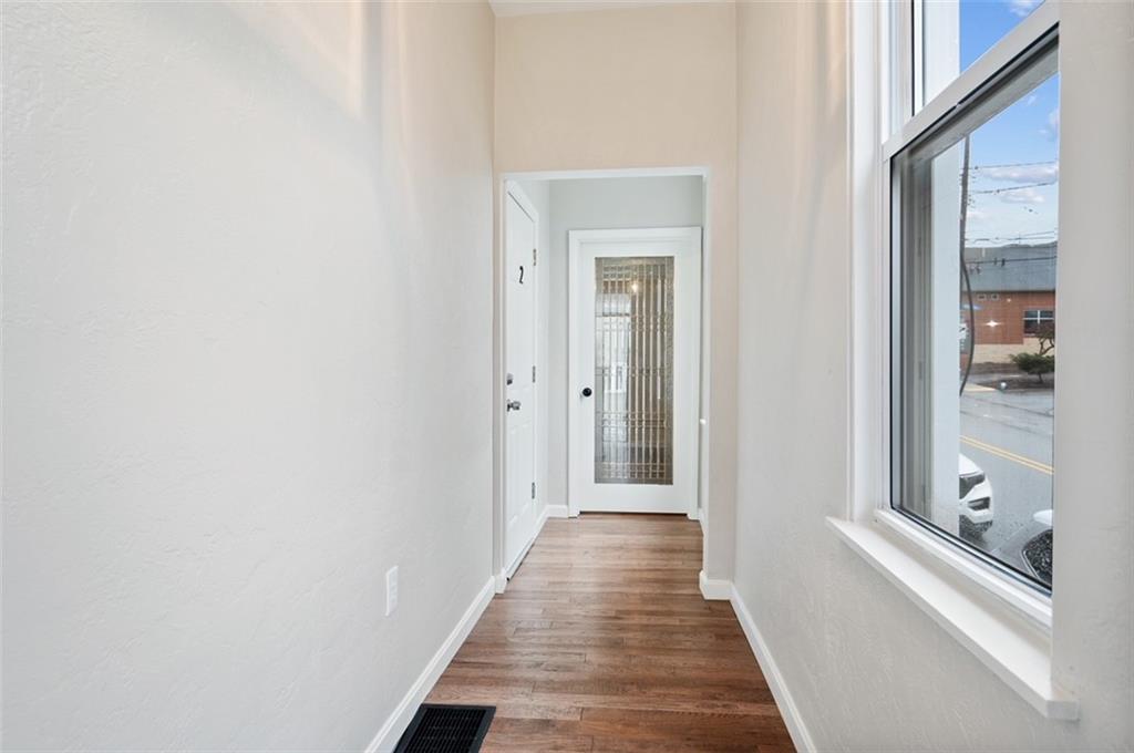 4827 Sciota Street Pittsburgh, PA 15224 - Photo 19 of 19 a view of a hallway with wooden floor and staircase