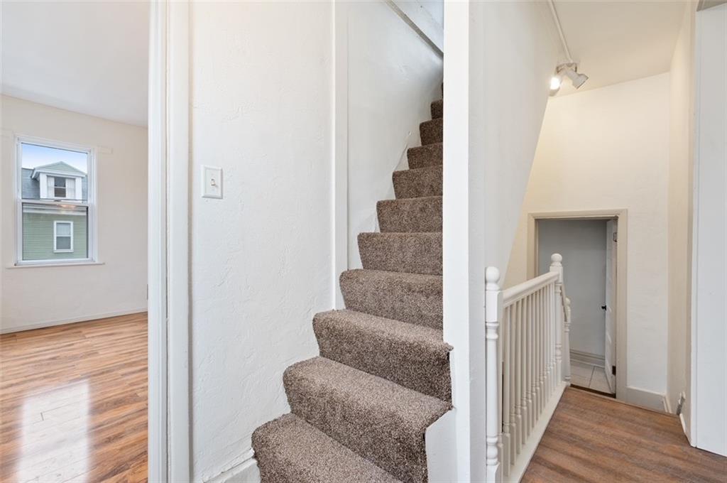4827 Sciota Street Pittsburgh, PA 15224 - Photo 5 of 19 a view of a hallway with couches and dining room view