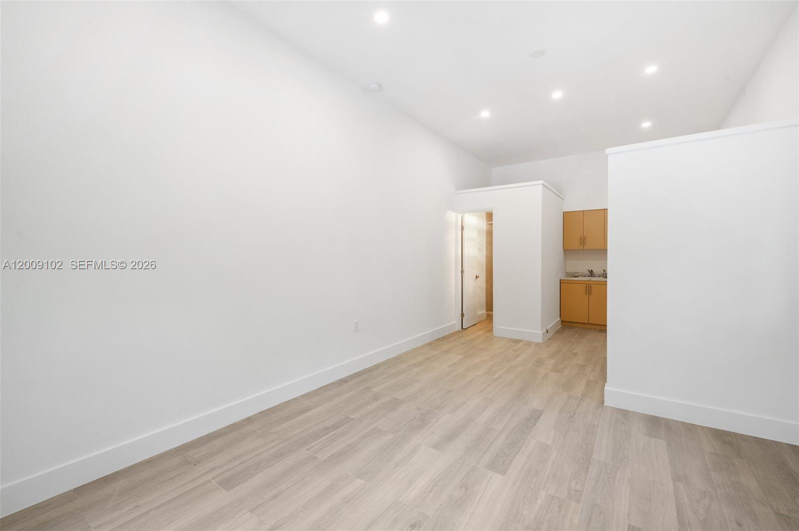 330 Southwest 27th Road Miami, FL 33129 - Photo 35 of 62 a view of an empty room with wooden floor and a window