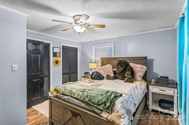 a view of a livingroom with a fireplace cabinet and a large window