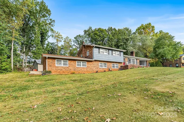 a house with green field in front of it