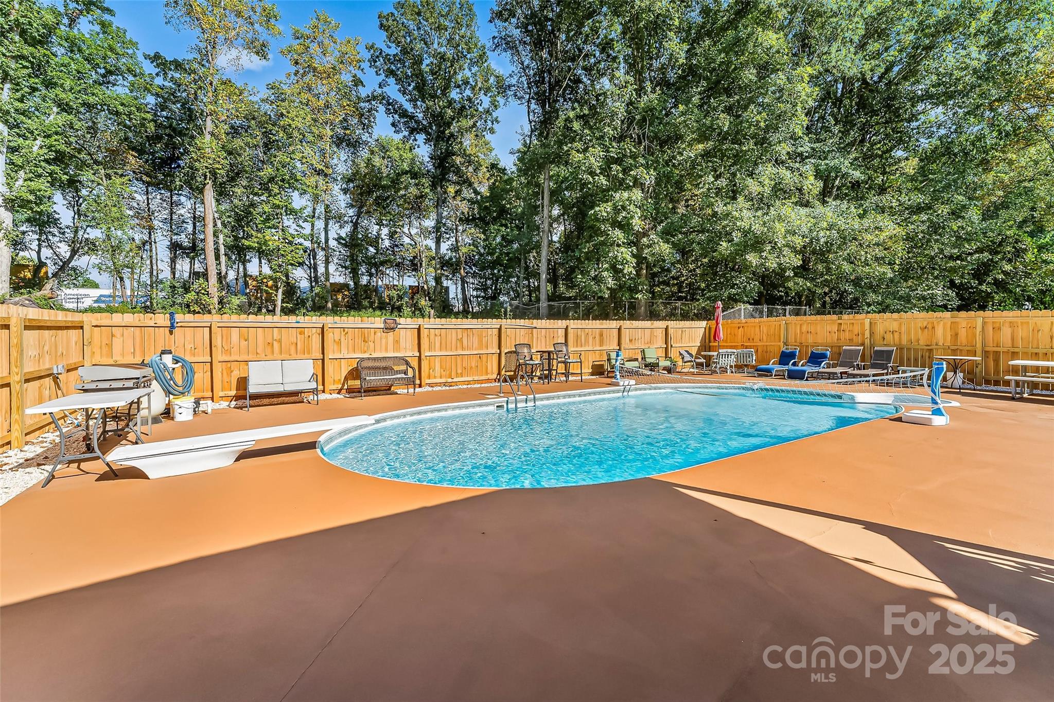 304 Parlier Avenue Conover, NC 28613 - Photo 28 of 37 a view of a swimming pool with an outdoor seating and a yard