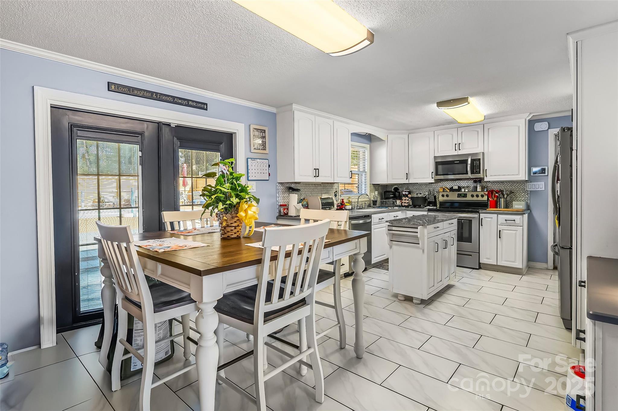 304 Parlier Avenue Conover, NC 28613 - Photo 7 of 37 a kitchen with stainless steel appliances kitchen island granite countertop a sink and cabinets