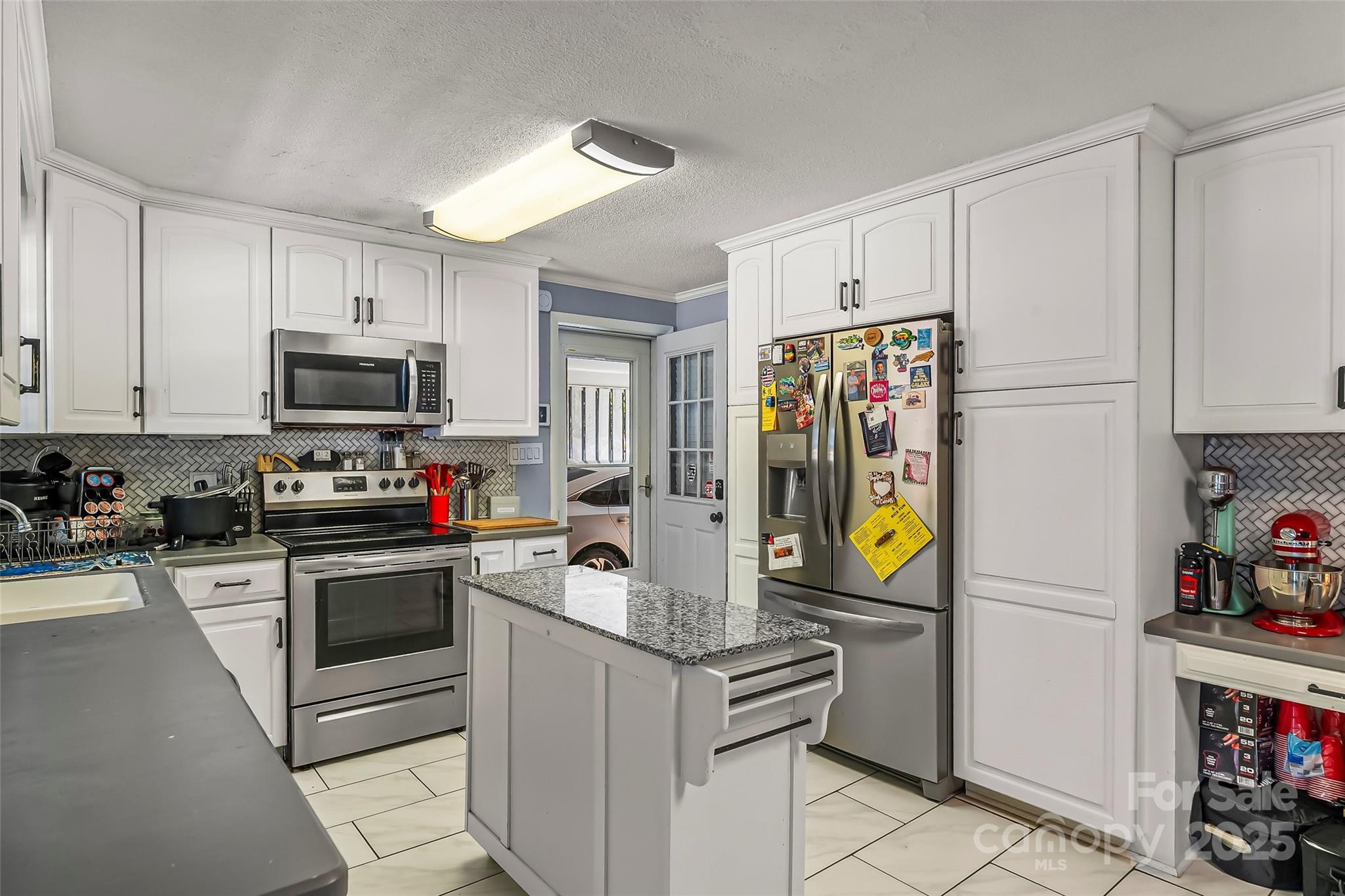 304 Parlier Avenue Conover, NC 28613 - Photo 10 of 37 a kitchen with stainless steel appliances granite countertop a stove and a refrigerator