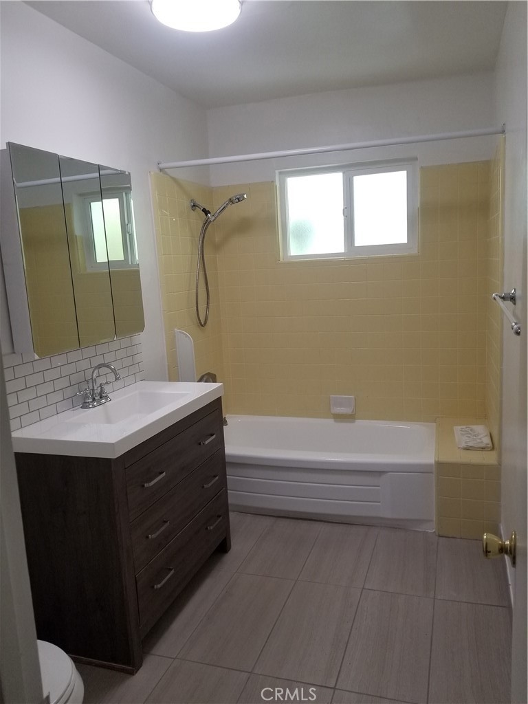 312 East Dryden Street, Unit 3 Glendale, CA 91207 - Photo 13 of 13 a bathroom with a tub sink and mirror
