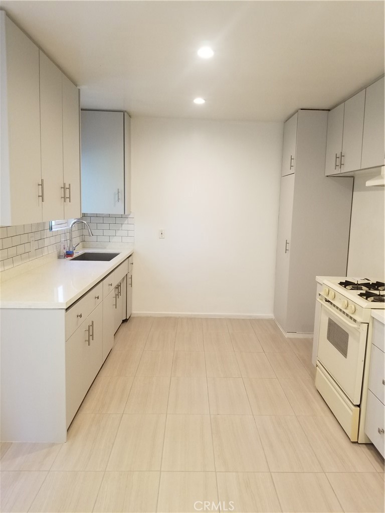 312 East Dryden Street, Unit 3 Glendale, CA 91207 - Photo 3 of 13 a kitchen with a stove sink and cabinets