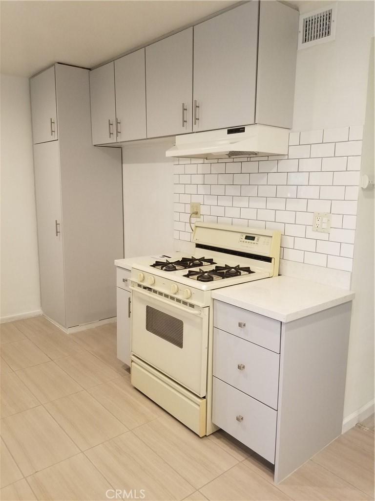 312 East Dryden Street, Unit 3 Glendale, CA 91207 - Photo 5 of 13 a kitchen with granite countertop white cabinets and white appliances