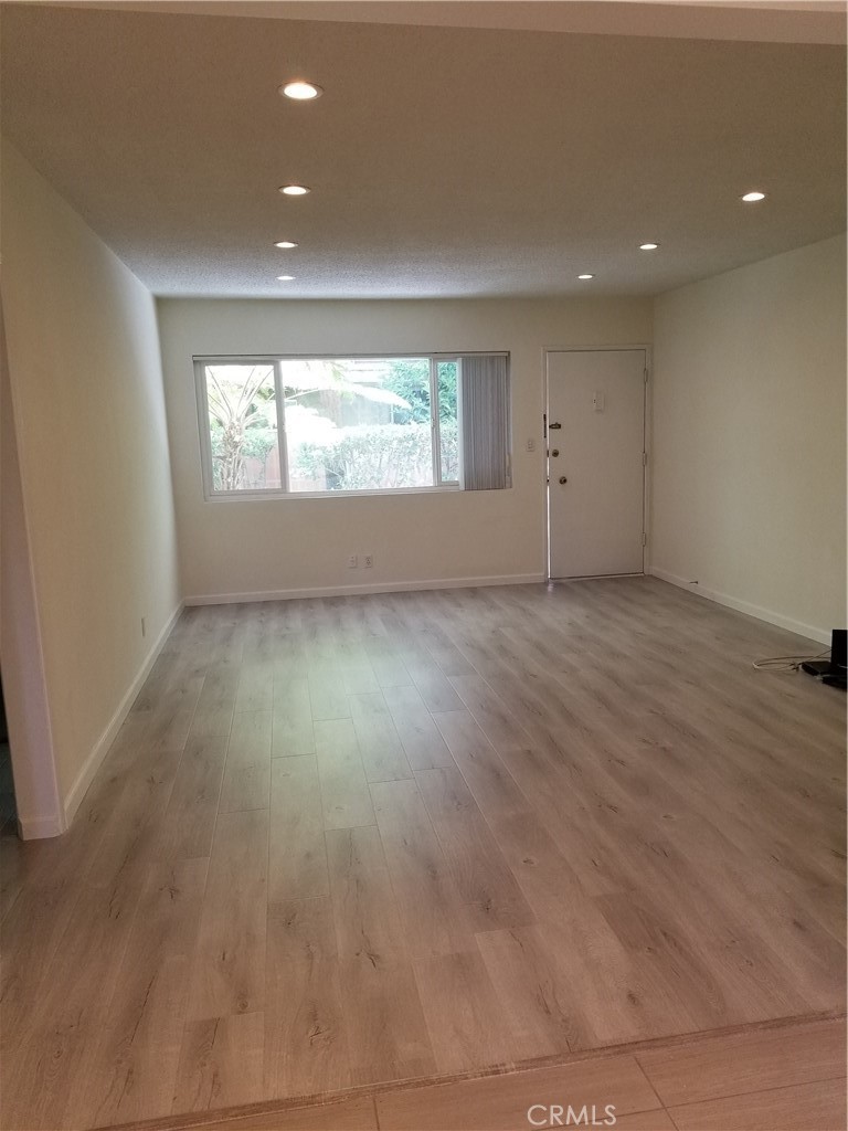 312 East Dryden Street, Unit 3 Glendale, CA 91207 - Photo 10 of 13 an empty room with wooden floor and windows