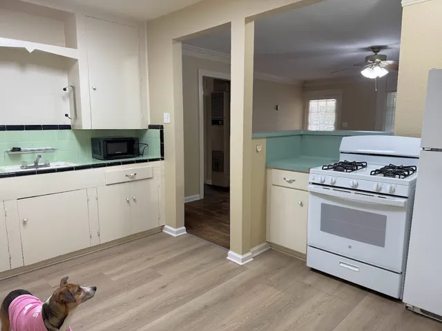 a kitchen with granite countertop a stove and a sink