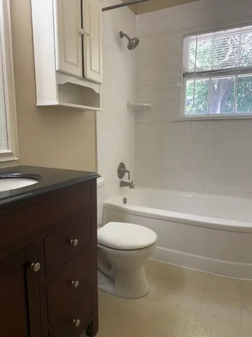 a bathroom with a sink a toilet and bathtub